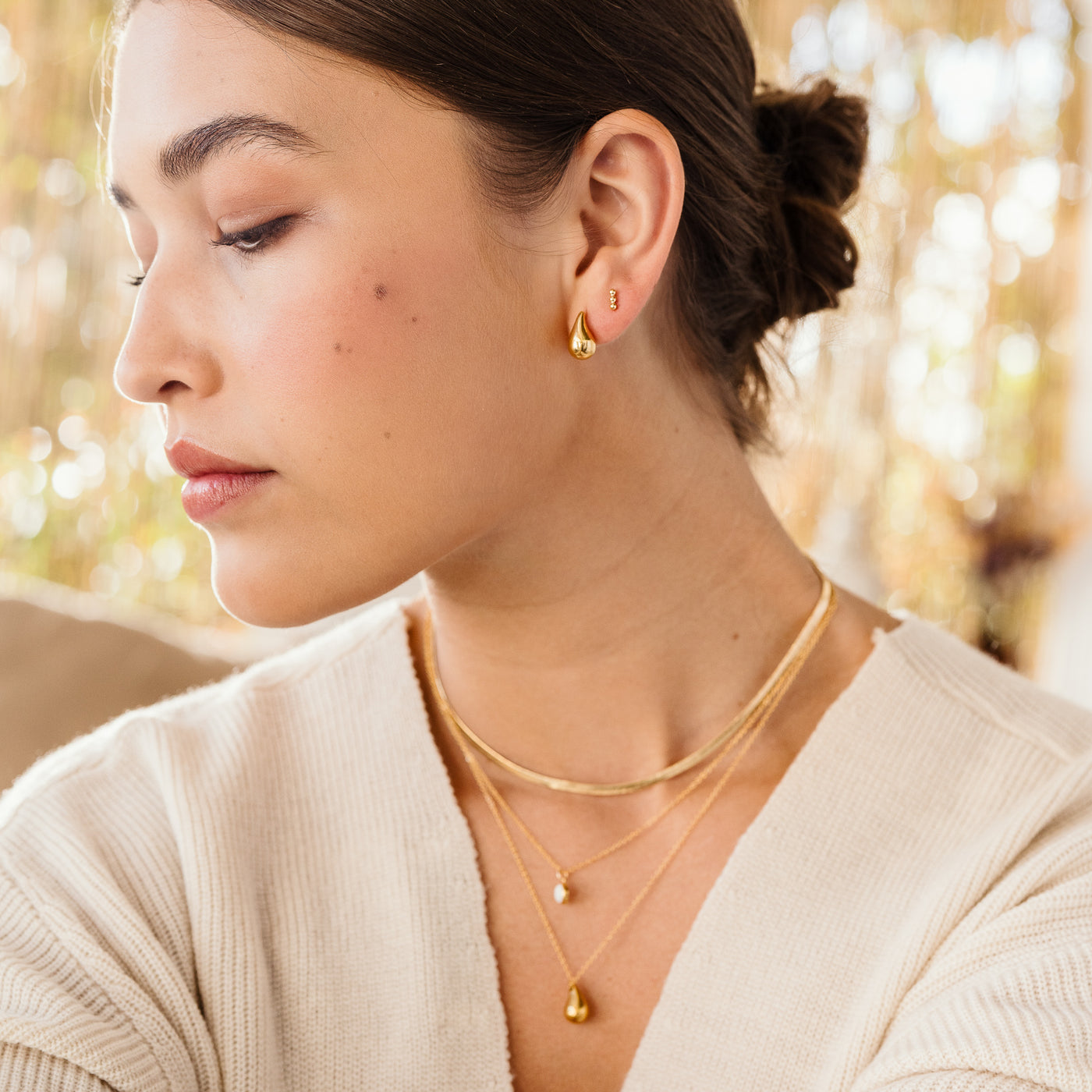 Small Large Teardrop Stud Earrings Woman in white sweater wearing gold herringbone necklace, opal necklace, and teardrop necklace